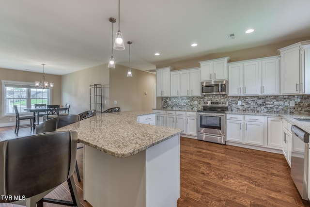 1447 Lemongrass Dr, Jonesborough, TN 37659 - kitchen featuring dark wood-type flooring, a notable chandelier, appliances with stainless steel finishes, and backsplash