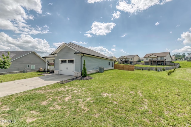 1447 Lemongrass Dr, Jonesborough, TN 37659 - view of side of property featuring a lawn, central AC, concrete driveway, an attached garage, and fence