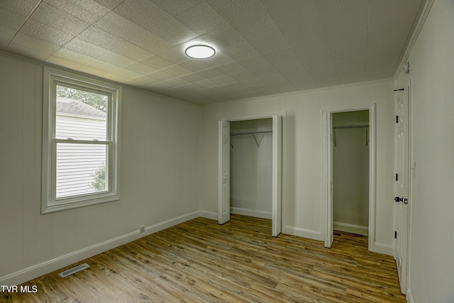 908 Columbia Rd, Bristol, TN 37620 - unfurnished bedroom with baseboards, wood finished floors, and visible vents