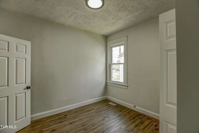908 Columbia Rd, Bristol, TN 37620 - empty room with baseboards, dark wood-type flooring, and visible vents