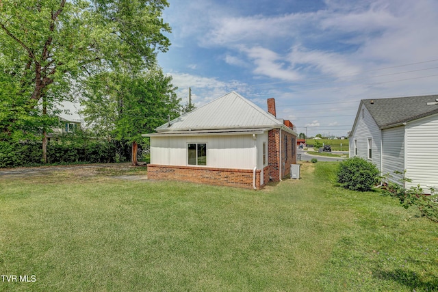 908 Columbia Rd, Bristol, TN 37620 - exterior space featuring a chimney, brick siding, and a yard