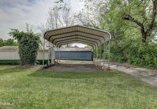 908 Columbia Rd, Bristol, TN 37620 - view of parking with a storage unit, a detached carport, and driveway