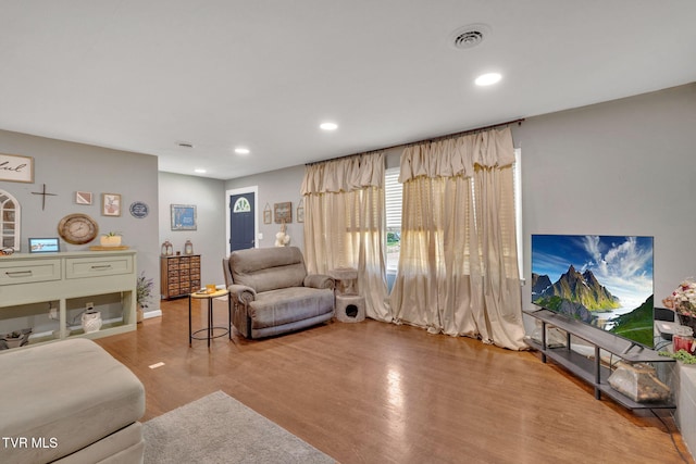 interior space featuring recessed lighting, baseboards, wood finished floors, and visible vents
