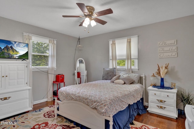 bedroom with baseboards, a ceiling fan, and wood finished floors