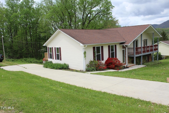 ranch-style house with a front lawn and a shingled roof