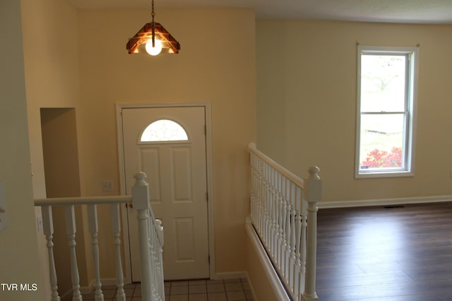 foyer with wood finished floors and baseboards