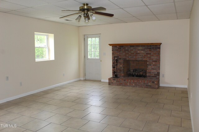 unfurnished living room with ceiling fan, a paneled ceiling, and plenty of natural light