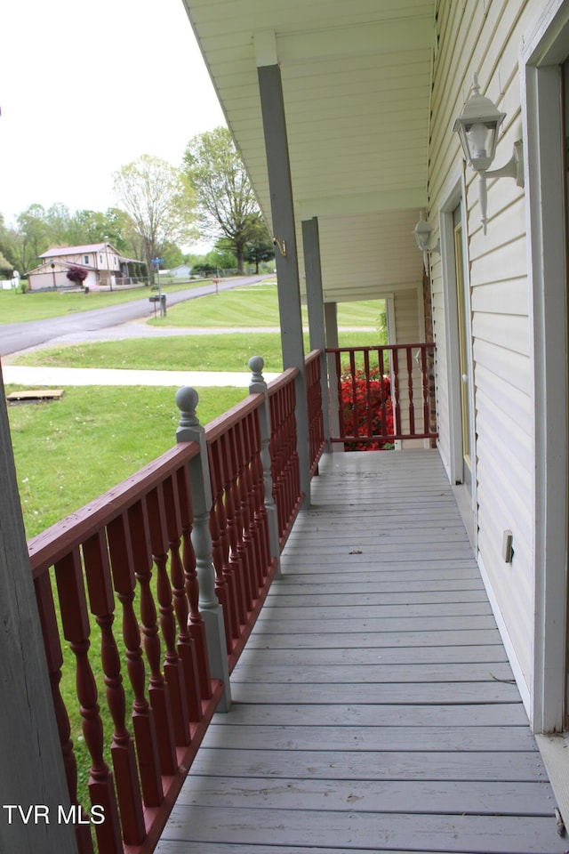 wooden deck with a porch and a yard