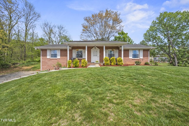 ranch-style house with a front lawn and brick siding