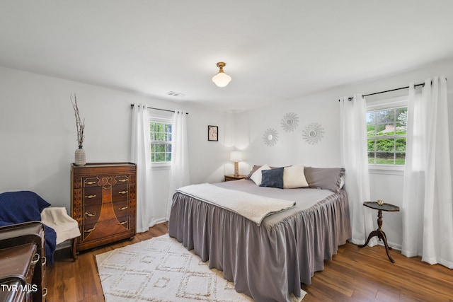 bedroom featuring wood finished floors and visible vents