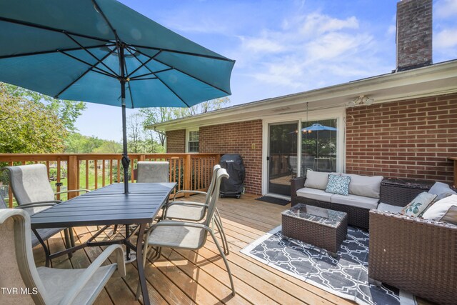 wooden terrace with an outdoor hangout area, outdoor dining area, and area for grilling