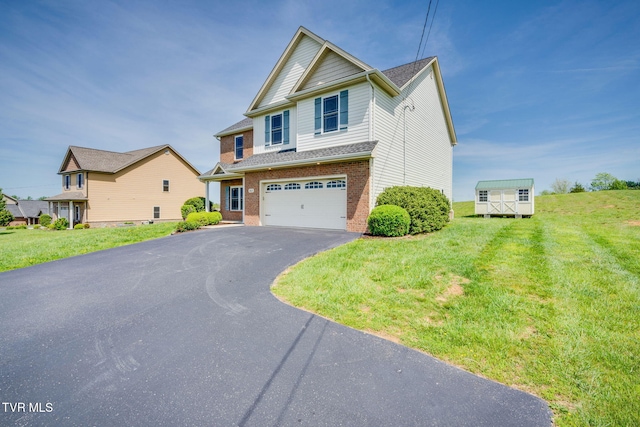 craftsman inspired home featuring brick siding, a front lawn, aphalt driveway, and a garage