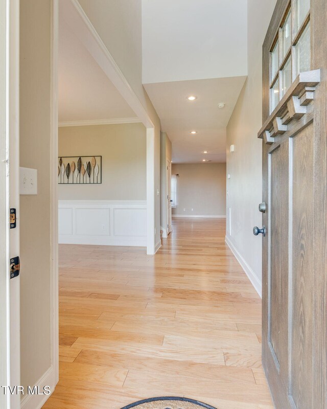 entrance foyer featuring baseboards, crown molding, light wood-style floors, and recessed lighting