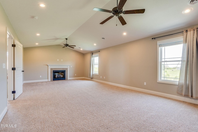 unfurnished living room featuring a ceiling fan, light carpet, a tiled fireplace, baseboards, and recessed lighting