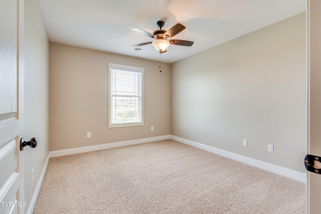 spare room with ceiling fan, baseboards, and carpet