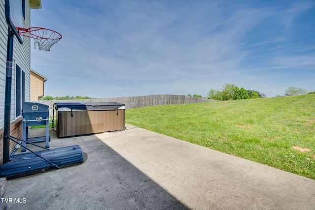 view of patio featuring a hot tub, area for grilling, and fence