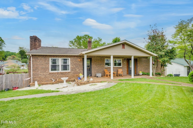 226 Delaney St, Bristol, TN 37620 - ranch-style home with roof with shingles, a chimney, fence, brick siding, and a front yard