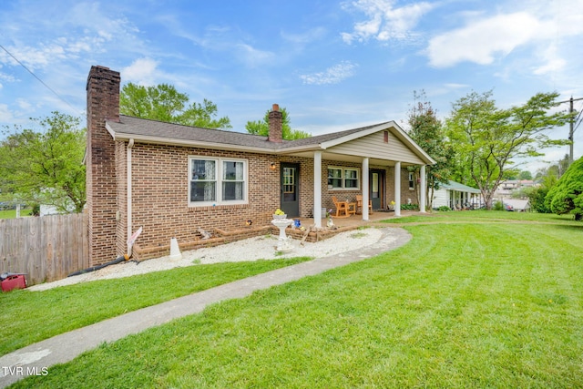 226 Delaney St, Bristol, TN 37620 - ranch-style house featuring a chimney, fence, a front yard, and brick siding