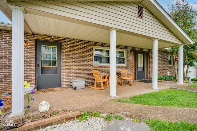 226 Delaney St, Bristol, TN 37620 - doorway to property featuring brick siding and a porch