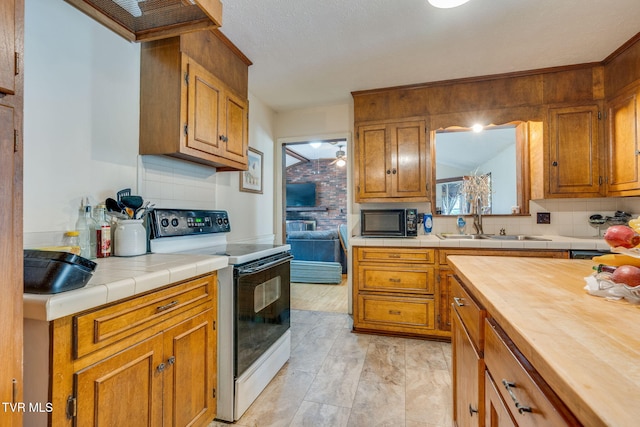 226 Delaney St, Bristol, TN 37620 - kitchen with black microwave, a sink, backsplash, and electric stove