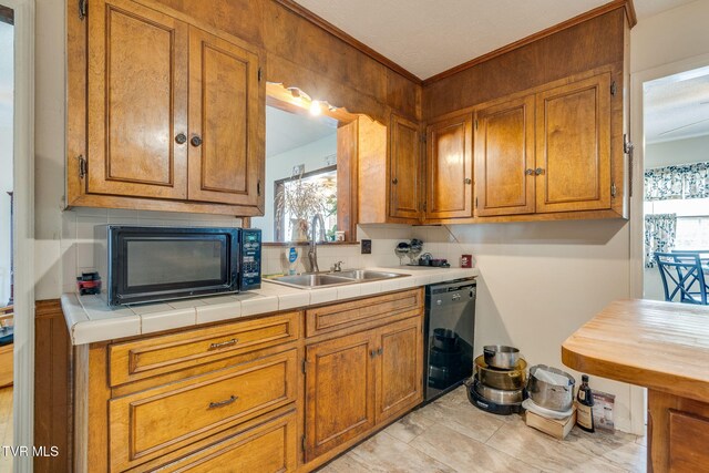 226 Delaney St, Bristol, TN 37620 - kitchen with a sink, backsplash, brown cabinetry, light countertops, and black appliances