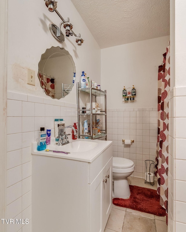 226 Delaney St, Bristol, TN 37620 - bathroom featuring tile patterned floors, a textured ceiling, vanity, tile walls, and toilet