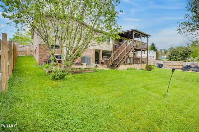 226 Delaney St, Bristol, TN 37620 - rear view of house with a fenced backyard, central AC, a wooden deck, brick siding, and stairway