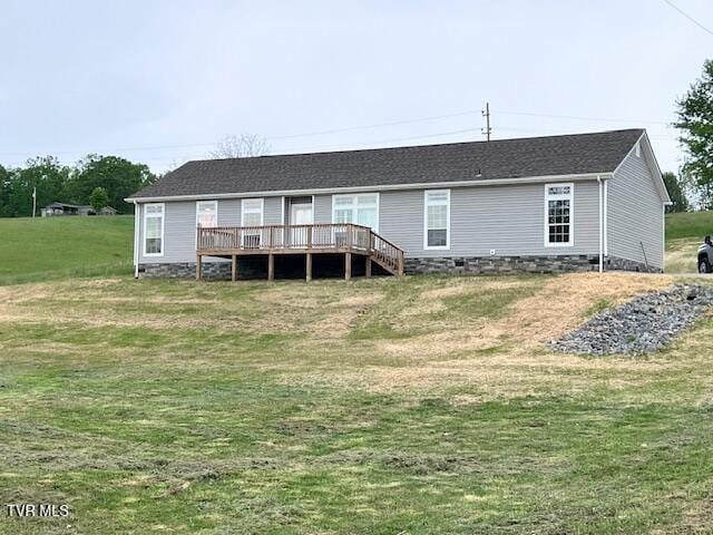 rear view of property featuring crawl space, a yard, and a deck