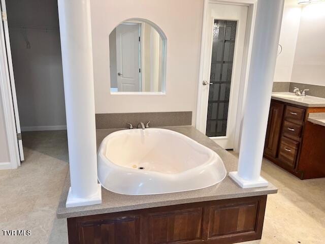 full bath with a bath and vanity
