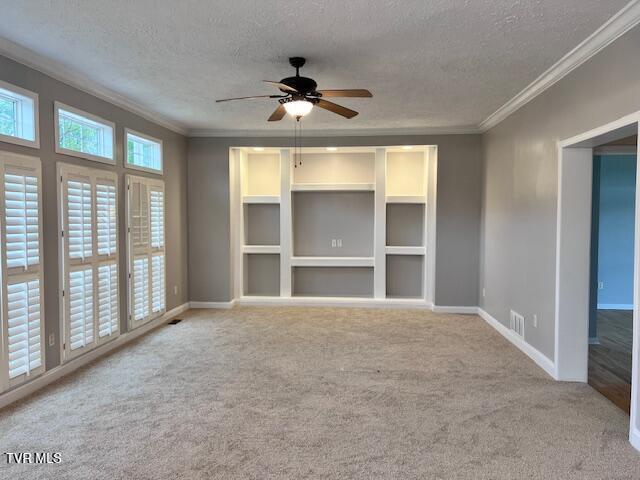 unfurnished room with baseboards, visible vents, a textured ceiling, and carpet flooring