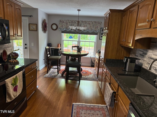 211 Michaels Ridge Blvd, Gray, TN 37615 - kitchen with a sink, decorative backsplash, electric range oven, a notable chandelier, and black microwave