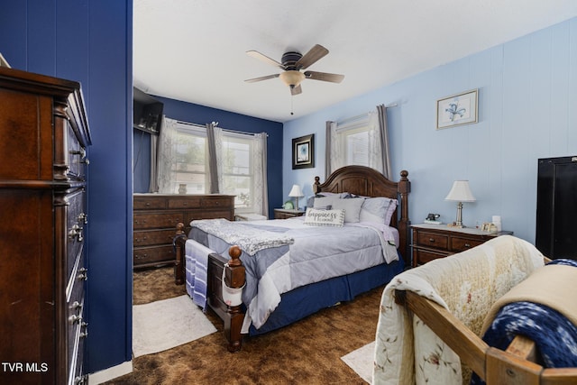 bedroom featuring multiple windows, a ceiling fan, and dark carpet