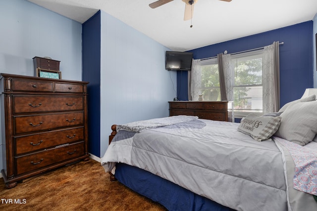 bedroom featuring ceiling fan and dark colored carpet