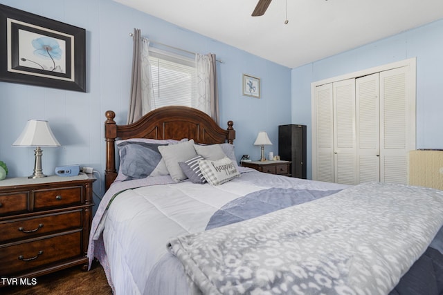 bedroom with a closet, ceiling fan, and dark carpet