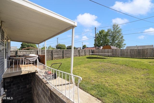 view of yard with a fenced backyard and a trampoline