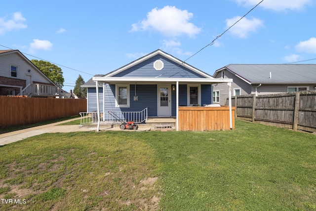 view of front of house featuring a fenced backyard, covered porch, and a front yard