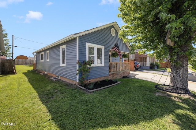 exterior space featuring fence and a yard