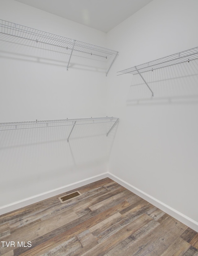 spacious closet with wood finished floors