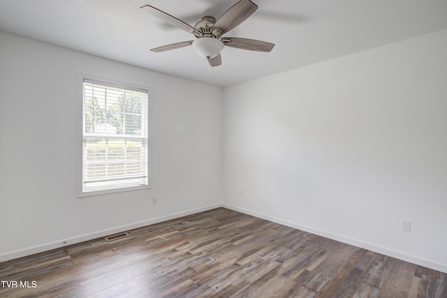 empty room featuring wood finished floors, ceiling fan, and baseboards