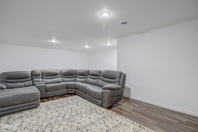 living room featuring wood finished floors, baseboards, and recessed lighting