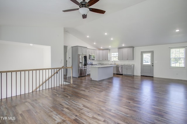 unfurnished living room featuring a ceiling fan, recessed lighting, dark wood-type flooring, healthy amount of natural light, and high vaulted ceiling