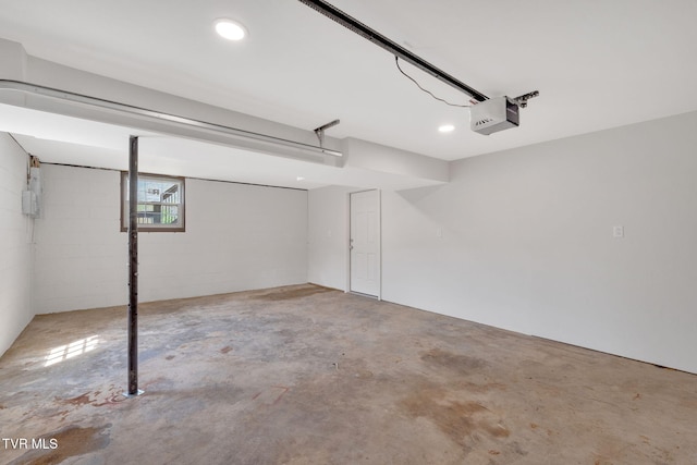 garage with recessed lighting and a garage door opener