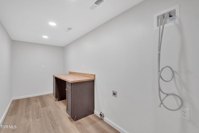 laundry area with washer hookup, laundry area, electric dryer hookup, visible vents, and light wood-style flooring
