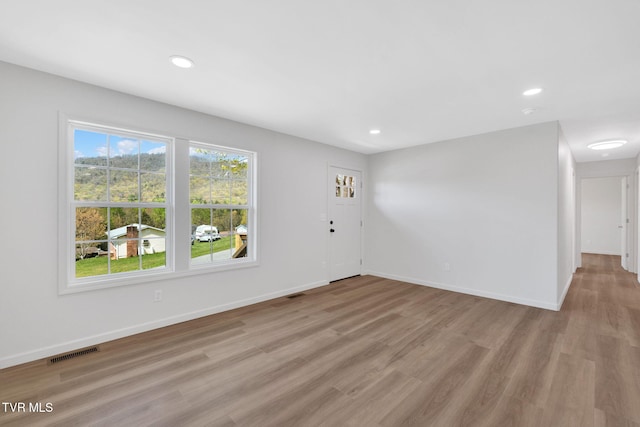 unfurnished living room featuring recessed lighting, visible vents, and light wood-type flooring