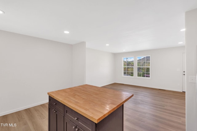interior space with baseboards, recessed lighting, and light wood-style flooring