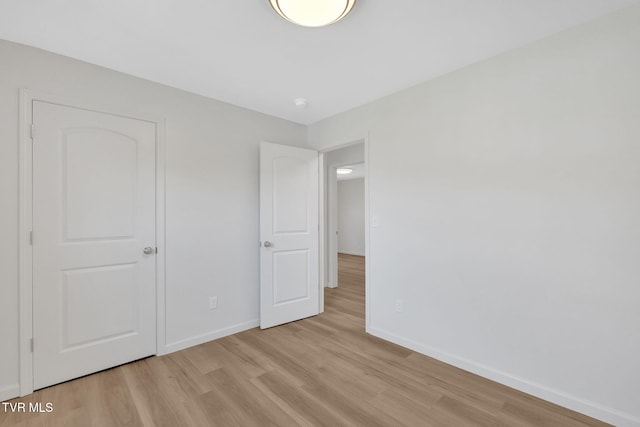 unfurnished bedroom featuring baseboards and light wood-style flooring