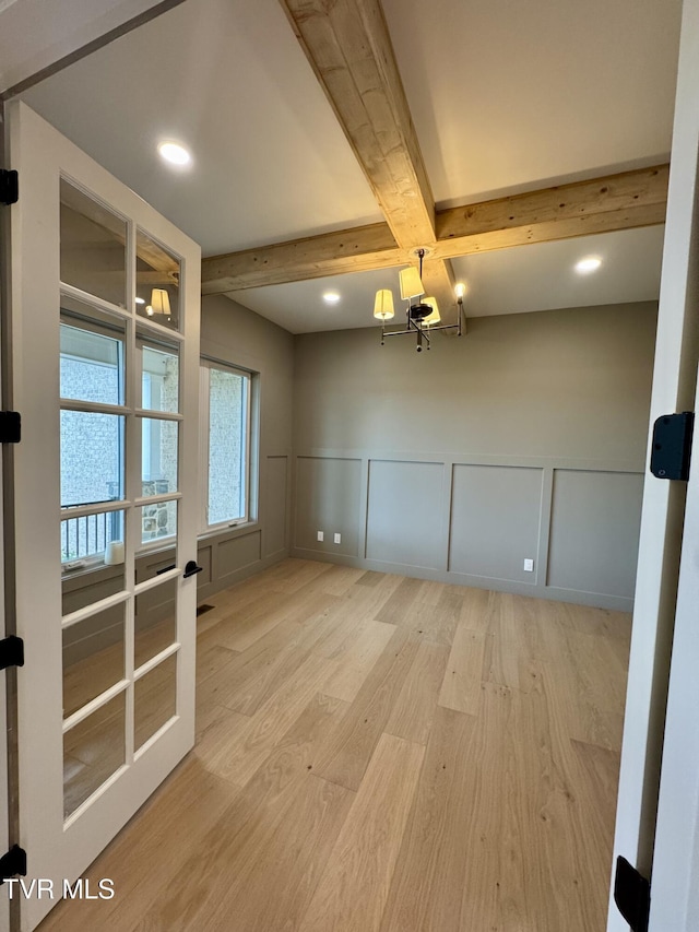 1093 Hawk Nest Ct, Jonesborough, TN 37659 - spare room with wood finished floors, a decorative wall, a chandelier, beamed ceiling, and wainscoting