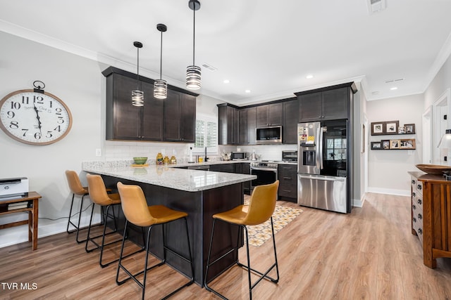 125 Lynn Rd, Johnson City, TN 37604 - kitchen featuring light stone countertops, a peninsula, ornamental molding, and appliances with stainless steel finishes