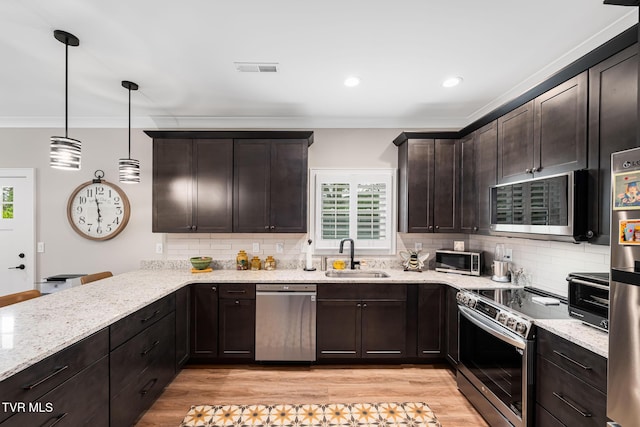 125 Lynn Rd, Johnson City, TN 37604 - kitchen featuring light stone counters, a sink, dark brown cabinetry, stainless steel appliances, and backsplash