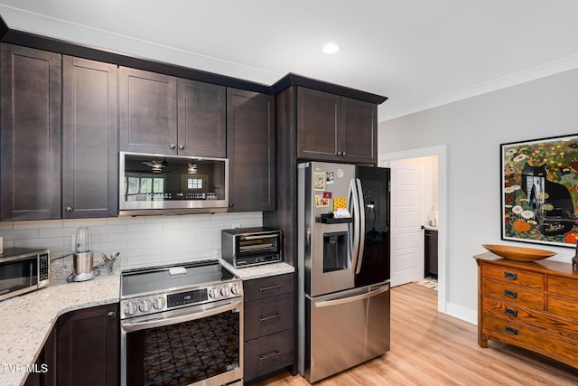 125 Lynn Rd, Johnson City, TN 37604 - kitchen with a toaster, light stone counters, light wood-style floors, decorative backsplash, and appliances with stainless steel finishes